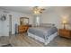 Spacious primary bedroom featuring wood flooring, bright natural light, and a ceiling fan at 12154 S Ki Rd, Phoenix, AZ 85044