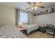 Bright bedroom featuring twin beds, ceiling fan and wood-look laminate flooring at 12154 S Ki Rd, Phoenix, AZ 85044