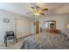 Serene bedroom boasts modern flooring, a ceiling fan, and ample closet space for storage at 12154 S Ki Rd, Phoenix, AZ 85044