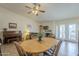 A dining area with access to a pool, complemented by a piano and a cozy living space with a fireplace at 12154 S Ki Rd, Phoenix, AZ 85044