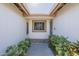 Inviting covered entryway featuring updated tile and lush greenery surrounding the front door at 12154 S Ki Rd, Phoenix, AZ 85044