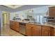 Open kitchen with bar seating, ample counter space, and natural light flowing into the adjacent dining and living areas at 12154 S Ki Rd, Phoenix, AZ 85044
