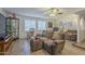 Comfortable living room with a soft sofa and rocking chair, complemented by large windows for natural light at 12154 S Ki Rd, Phoenix, AZ 85044