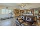 A living room with a leather sofa, a dining area, and a glimpse into the kitchen, creating a harmonious living space at 12154 S Ki Rd, Phoenix, AZ 85044