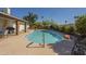 Backyard pool is surrounded by stone pavers, lush trees, and rock features creating a private retreat at 12154 S Ki Rd, Phoenix, AZ 85044