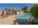 Relaxing backyard pool features lounge chairs and an outdoor table with barbecue under a covered patio at 12154 S Ki Rd, Phoenix, AZ 85044