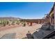 Desert landscaping in backyard with lounge chairs and brick patio at 12538 E Pivot Peak --, Gold Canyon, AZ 85118