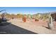 Desert landscaped backyard with comfortable seating and a brick patio at 12538 E Pivot Peak --, Gold Canyon, AZ 85118