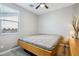 Bedroom featuring a queen bed, ceiling fan, and bedside table at 12538 E Pivot Peak --, Gold Canyon, AZ 85118