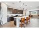 Bright kitchen featuring a large center island with seating, dark wood cabinets, and modern appliances at 12538 E Pivot Peak --, Gold Canyon, AZ 85118