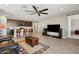 Open concept living room with kitchen features modern island seating and a ceiling fan at 12538 E Pivot Peak --, Gold Canyon, AZ 85118