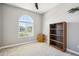 Office featuring a bookshelf, arched window, and carpet flooring at 12538 E Pivot Peak --, Gold Canyon, AZ 85118
