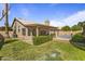Spacious backyard with mature trees, green grass, and pool with patio at 1413 E San Remo Ave, Gilbert, AZ 85234