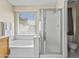 Bright bathroom featuring soaking tub and glass shower at 1413 E San Remo Ave, Gilbert, AZ 85234