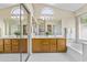 Bright bathroom boasts double vanity, soaking tub, and large closet with mirrored doors at 1413 E San Remo Ave, Gilbert, AZ 85234