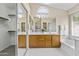 Bright bathroom boasts double vanity, soaking tub, and large closet with mirrored doors at 1413 E San Remo Ave, Gilbert, AZ 85234