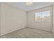 Bright bedroom featuring neutral walls, plush carpeting, and a window offering natural light at 1413 E San Remo Ave, Gilbert, AZ 85234