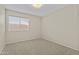 Bright bedroom featuring neutral walls, plush carpeting, and a window offering natural light at 1413 E San Remo Ave, Gilbert, AZ 85234