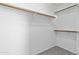 Walk-in closet features carpet, white walls, and wooden railing at 1413 E San Remo Ave, Gilbert, AZ 85234
