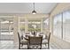 Bright dining area with outdoor view and a stylish round wooden table at 1413 E San Remo Ave, Gilbert, AZ 85234