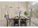 Well-lit dining area featuring modern decor, a stylish chandelier, and views to the exterior at 1413 E San Remo Ave, Gilbert, AZ 85234
