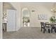 Inviting dining area with plush carpet, neutral walls, and an open doorway view to the backyard at 1413 E San Remo Ave, Gilbert, AZ 85234