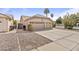 Charming home featuring a two-car garage, desert landscaping, and spacious driveway at 1413 E San Remo Ave, Gilbert, AZ 85234