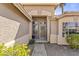 Inviting front entrance with decorative door, covered porch, and desert-friendly landscaping at 1413 E San Remo Ave, Gilbert, AZ 85234