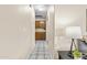 Hallway featuring access to the kitchen with tile floors and neutral paint at 1413 E San Remo Ave, Gilbert, AZ 85234