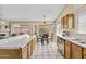 Open kitchen with oak cabinets, stainless appliances, and sliding glass doors to a backyard at 1413 E San Remo Ave, Gilbert, AZ 85234