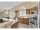 Bright kitchen with tile floors, oak cabinets, stainless appliances, and a garden window at 1413 E San Remo Ave, Gilbert, AZ 85234
