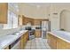 Traditional kitchen with stainless appliances, tile floors, light wood cabinets, and white countertops at 1413 E San Remo Ave, Gilbert, AZ 85234