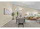 Open-concept living and dining area with plush carpet, a large window, and contemporary furnishings at 1413 E San Remo Ave, Gilbert, AZ 85234