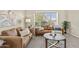 Comfortable living room with stylish seating, neutral tones, and bright, natural lighting at 1413 E San Remo Ave, Gilbert, AZ 85234