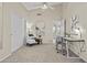 Inviting home office with vaulted ceilings, modern chair, and open doorway to the living area at 1413 E San Remo Ave, Gilbert, AZ 85234