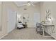 Inviting home office with vaulted ceilings, modern chair, and open doorway to the living area at 1413 E San Remo Ave, Gilbert, AZ 85234