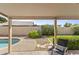 Covered patio with a view of the swimming pool, landscaped backyard, and privacy wall at 1413 E San Remo Ave, Gilbert, AZ 85234