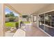 Spacious covered patio with a chair, tile flooring, and backyard view, perfect for outdoor relaxation at 1413 E San Remo Ave, Gilbert, AZ 85234