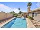 Backyard pool with brick surround, palm trees, and well-maintained landscaping at 1413 E San Remo Ave, Gilbert, AZ 85234