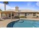 Sparkling pool with step-in entry, covered patio, and manicured landscaping at 1413 E San Remo Ave, Gilbert, AZ 85234