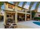 Beautiful backyard with patio, balcony, outdoor seating, fire pit, spa, and manicured landscaping at 14228 W Weldon Ave, Goodyear, AZ 85395