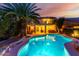 Exterior view of a pool and backyard area with patio, landscaping, and outdoor kitchen at 14228 W Weldon Ave, Goodyear, AZ 85395