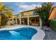 Backyard showcasing a stunning pool with mature greenery and privacy features at 14228 W Weldon Ave, Goodyear, AZ 85395