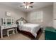 Cozy bedroom featuring a vanity, dresser, and a window that brings in natural light at 14228 W Weldon Ave, Goodyear, AZ 85395