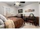 Cozy bedroom featuring a window, dresser, vanity, and neutral color palette at 14228 W Weldon Ave, Goodyear, AZ 85395