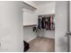 Walk-in closet with shelving and hanging rods, providing ample storage space at 14228 W Weldon Ave, Goodyear, AZ 85395