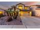 Well-maintained home with gravel landscaping, mature trees and a spacious two car garage at 14228 W Weldon Ave, Goodyear, AZ 85395
