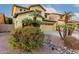 Charming home featuring desert landscaping, a two-car garage, and a welcoming entrance at 14228 W Weldon Ave, Goodyear, AZ 85395