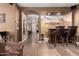 Open hallway showcases tiled floors, archway, and a view of the front entry and bar at 14228 W Weldon Ave, Goodyear, AZ 85395