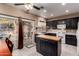 Well-equipped kitchen with a central island, dark cabinetry, and access to the backyard patio at 14228 W Weldon Ave, Goodyear, AZ 85395